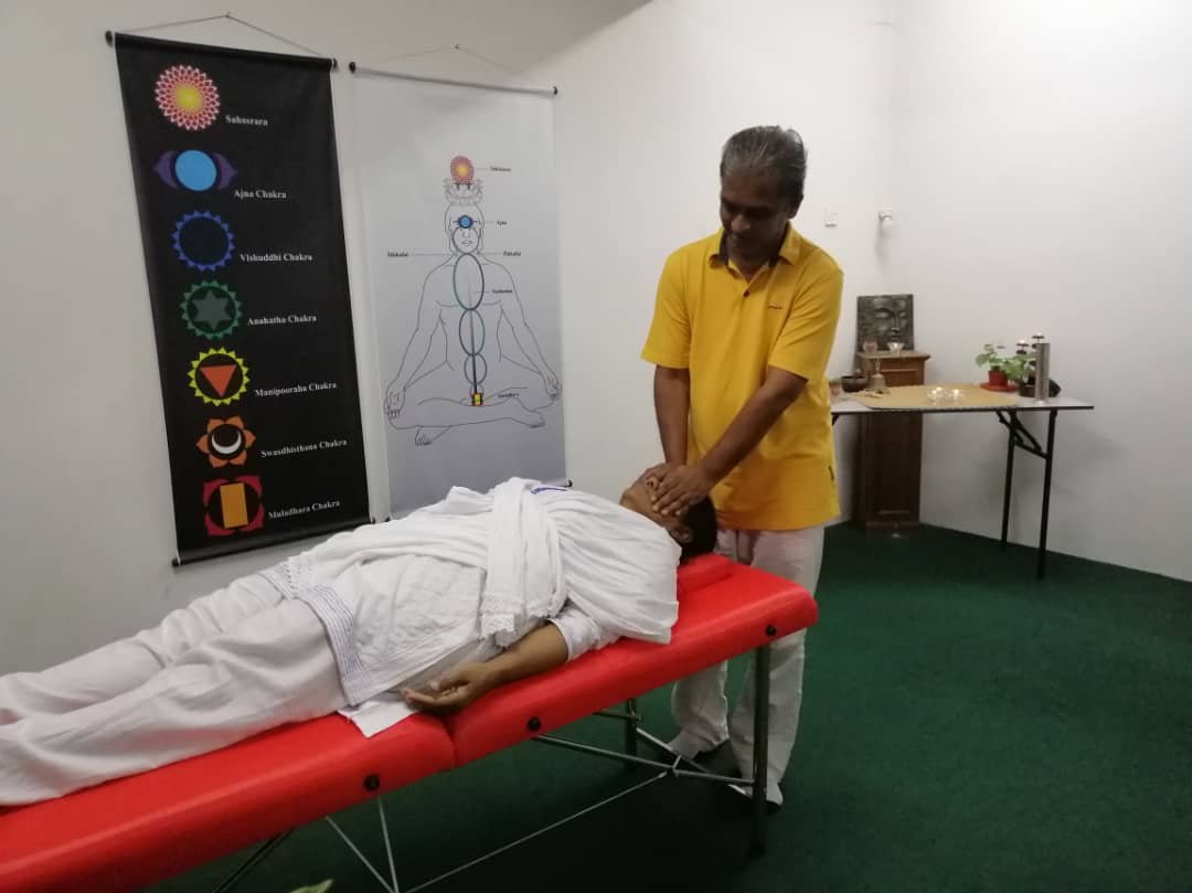 0d31b49c-e22a-4087-bff7-d427153a57d6 Mindfulness & Well-being - Asohan demonstrating healing or therapy on a table